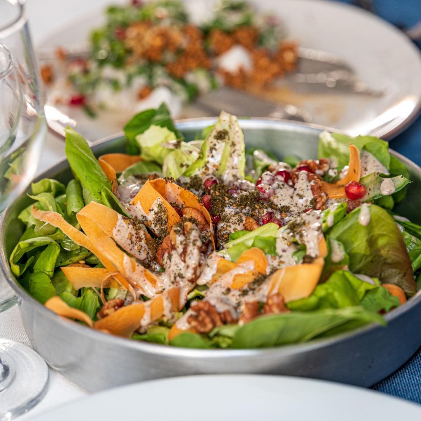 Fresh green salad with carrots and walnuts